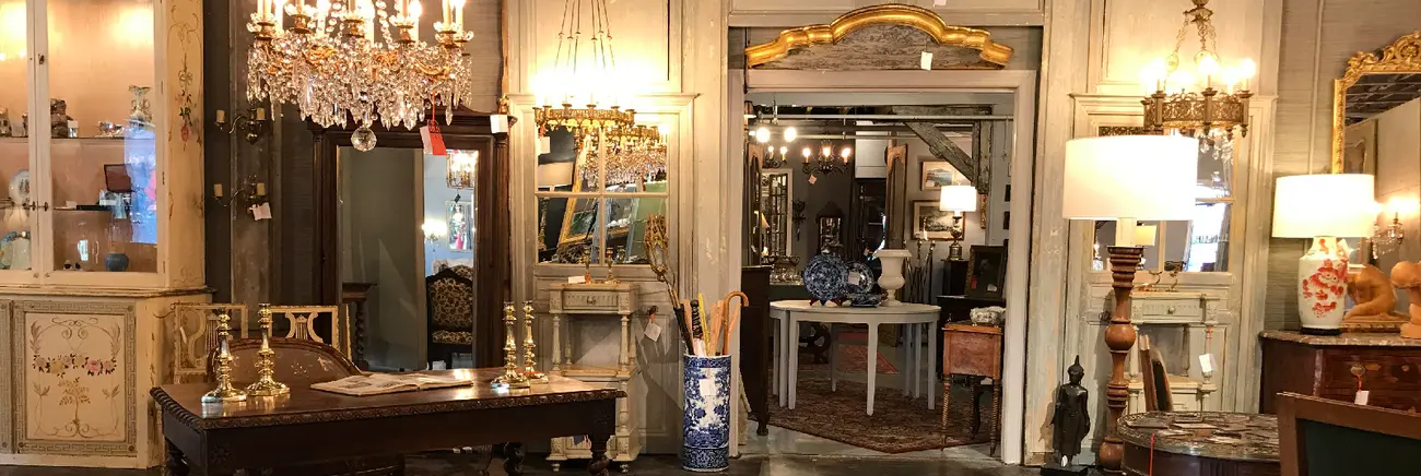 Michael Millard-Lowe among antiques in the shop